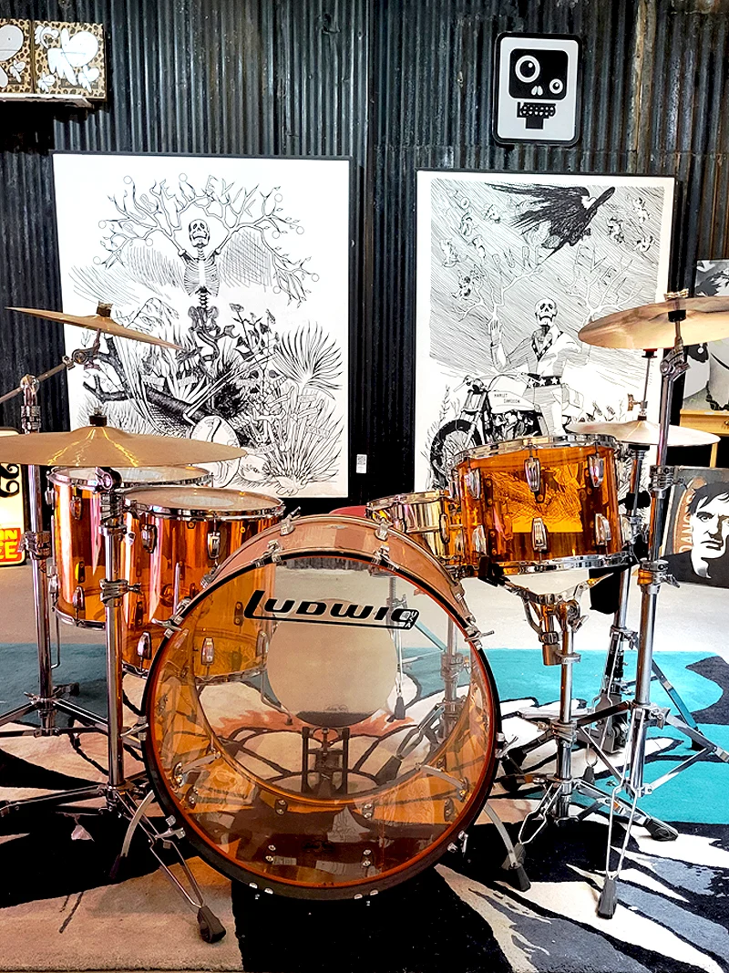 Drum kit installation with black and white artwork at Pure Evil Gallery Shoreditch
