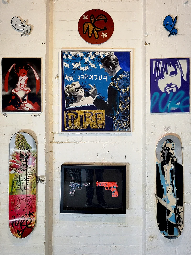 Mixed artworks and skateboard decks displayed at Pure Evil Gallery Shoreditch London