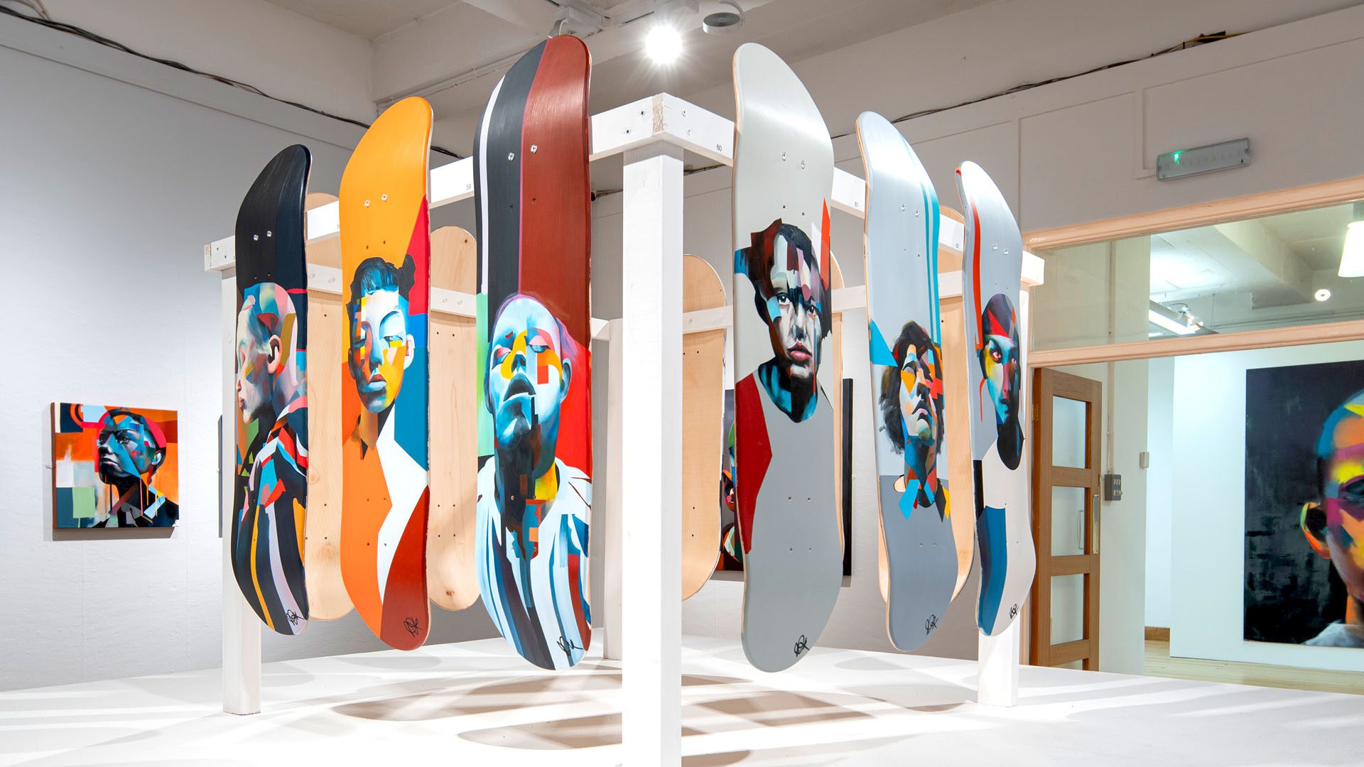 Skateboards at PAINtings exhibition by Paul Kneen