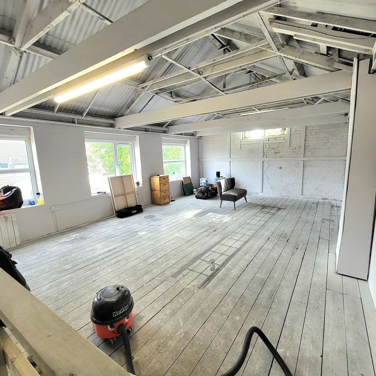 Art studio in Peterborough during renovation with freshly painted white walls and cleaning in progress