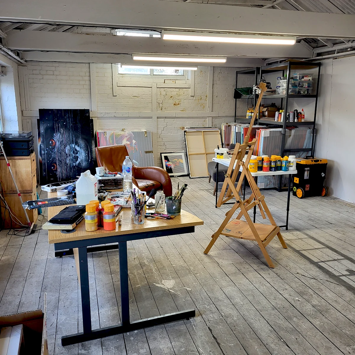 Paul Kneen’s art studio workspace in Peterborough with easel, paints and canvases