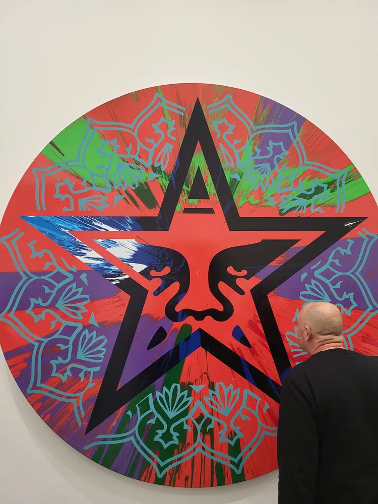 Large circular painting created by Damien Hirst and Shepard Fairey