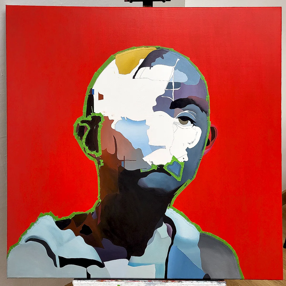 Unfinished abstract portrait painting on canvas showing layered masking and partially completed face