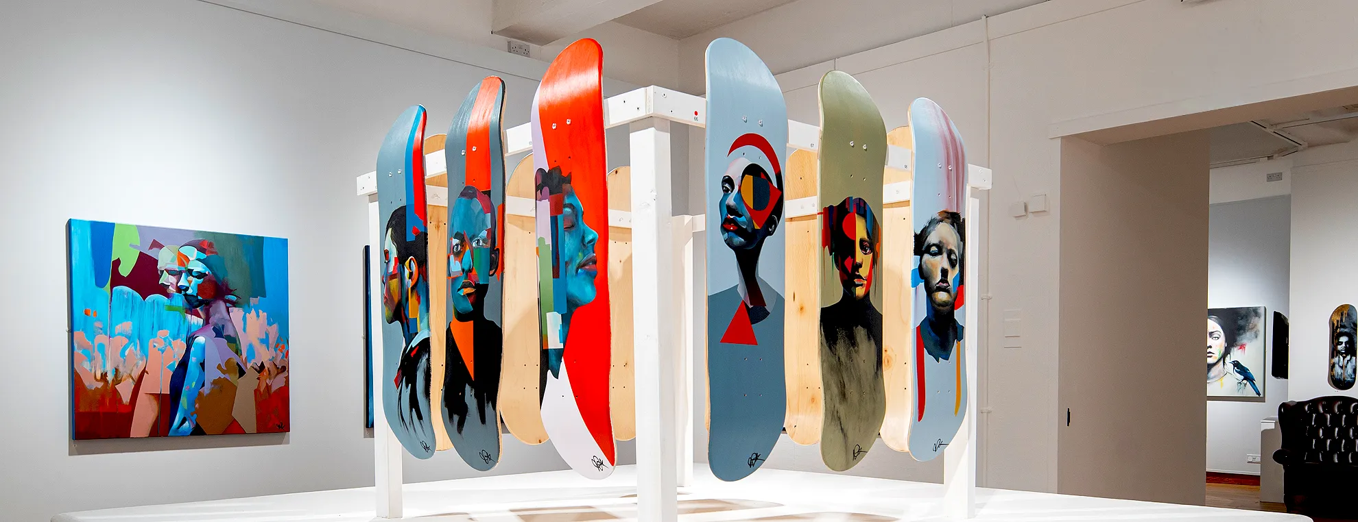 Original hand-painted skateboard decks by abstract portrait artist Paul Kneen displayed at Peterborough Museum & Art Gallery.
